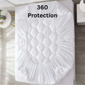 White quilted mattress protector with 360 protection, fitted snugly on bed for full coverage