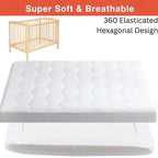 White mattress cover with text about softness and design, next to a wooden crib.