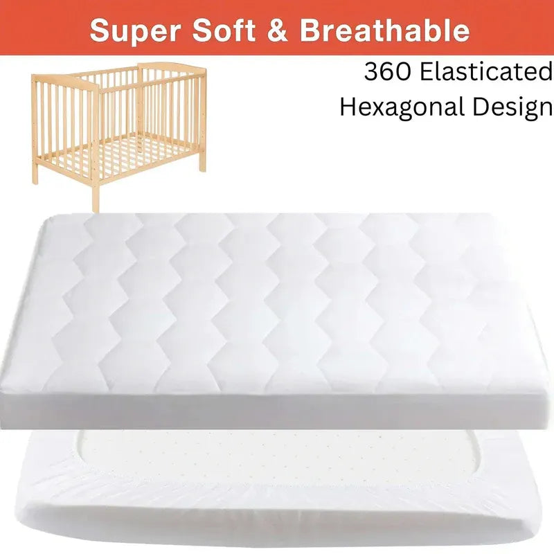 White mattress cover with text about softness and design, next to a wooden crib.