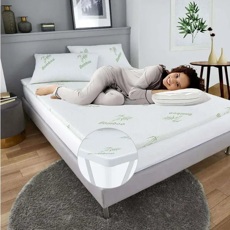 Woman lying on a bed with bamboo mattress topper in a bedroom setting