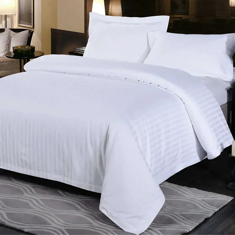 White bedding set on a bed in a bedroom setting