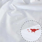 Red liquid stain on a white fabric with a circular outline.