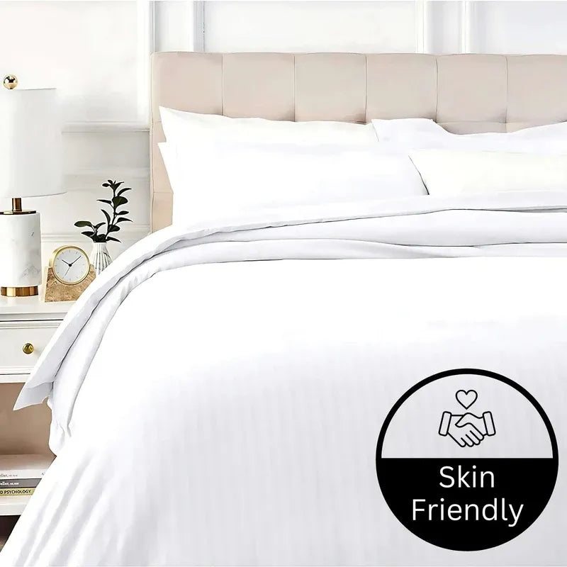 White bedding set on a bed with a 'Skin Friendly' label in the corner.
