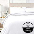 White bedding set on a bed with a 'Skin Friendly' label in the corner.