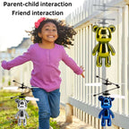 Child playing with flying teddy bear toys outdoors