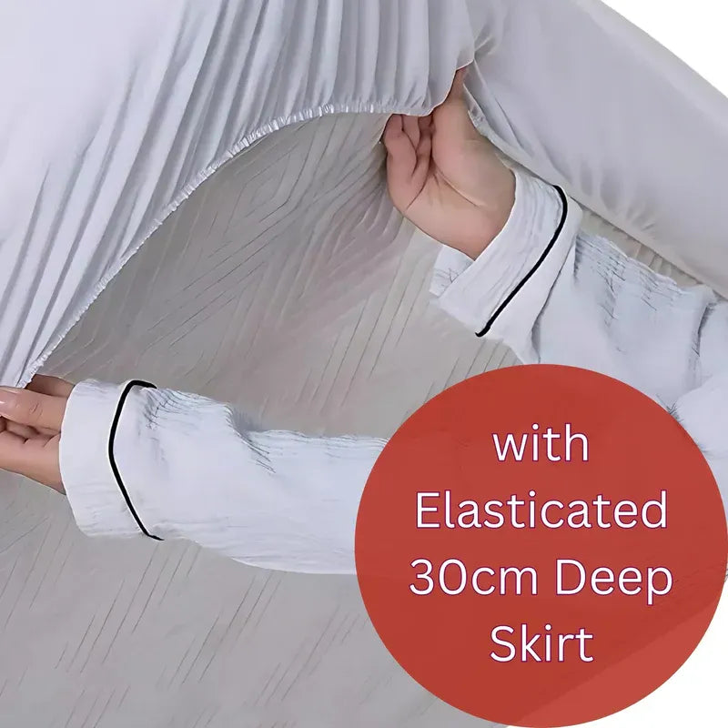 White nightgown with elasticated 30cm deep skirt held by a hand on a light background.