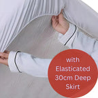 White nightgown with elasticated 30cm deep skirt held by a hand on a light background.