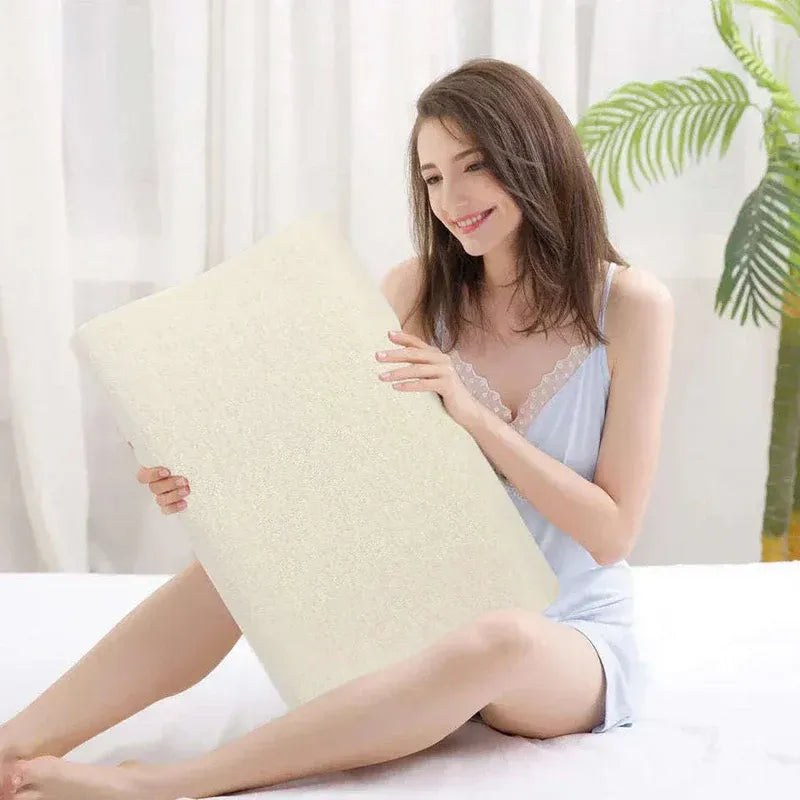 Woman holding a large pillow in a bedroom setting