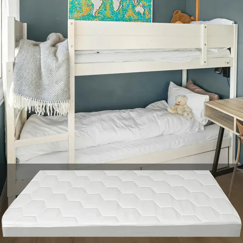 White bunk bed with a mattress on a wooden floor against a gray wall.