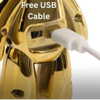 Gold electronic device with a white USB cable plugged in, on a white background.