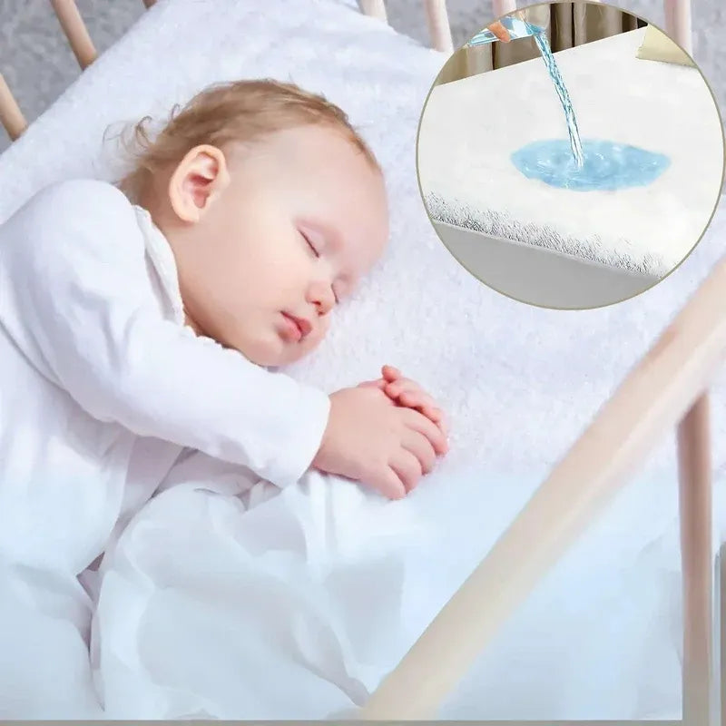 Baby sleeping peacefully with a close-up of water droplets on a white surface.