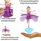 Fairy doll toy with instructions on how to operate it, including turning on a switch and placing it in an open palm.