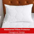 White waterproof pillow protector with hexagonal design on a bed, featuring a brown headboard.