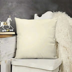 Beige pillow on a chair with a decorative horse figure in the background