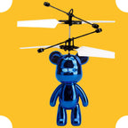 Blue teddy bear-shaped RC helicopter on a yellow background