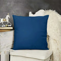 Blue pillow on a white chair with a gray wall and decorative horse in the background