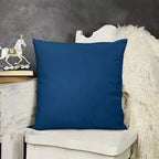 Blue pillow on a white chair with a gray wall and decorative horse in the background