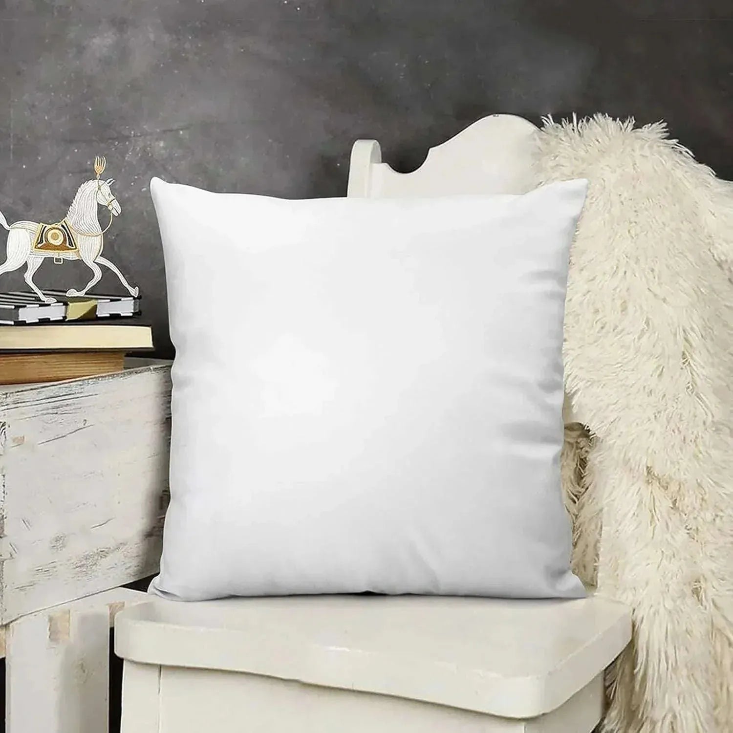 White pillow on a chair with a decorative horse figure in the background