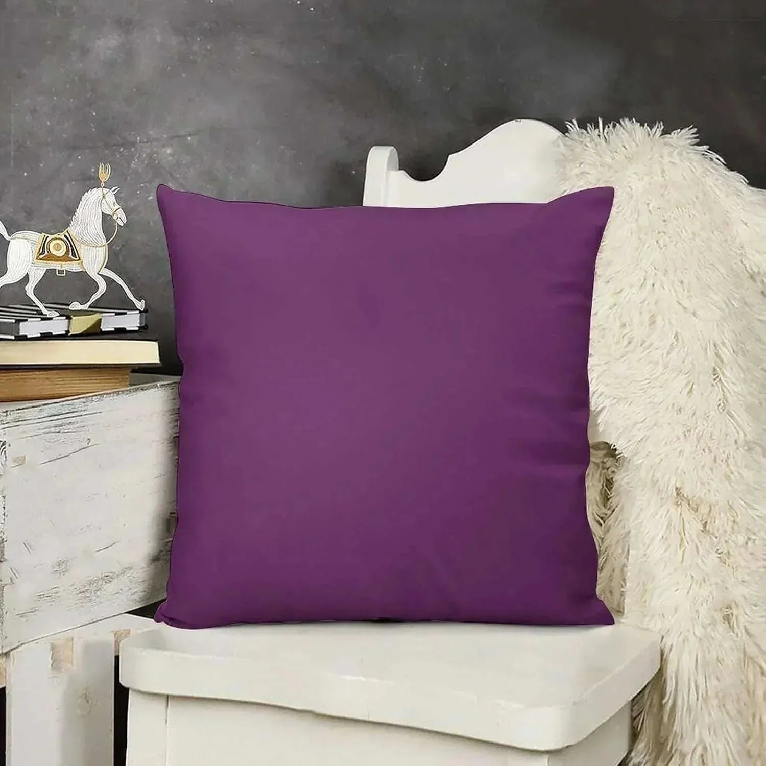Purple pillow on a white chair with a dark gray background