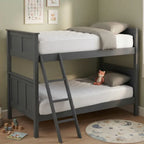 A dark gray wooden bunk bed with a built-in ladder, styled with white mattresses, gray pillows, and a small plush toy in a child's bedroom.