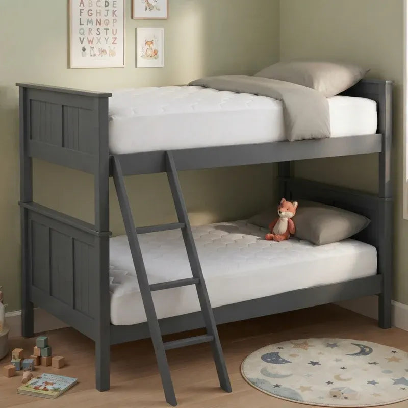 A dark gray wooden bunk bed with a built-in ladder, styled with white mattresses, gray pillows, and a small plush toy in a child's bedroom.